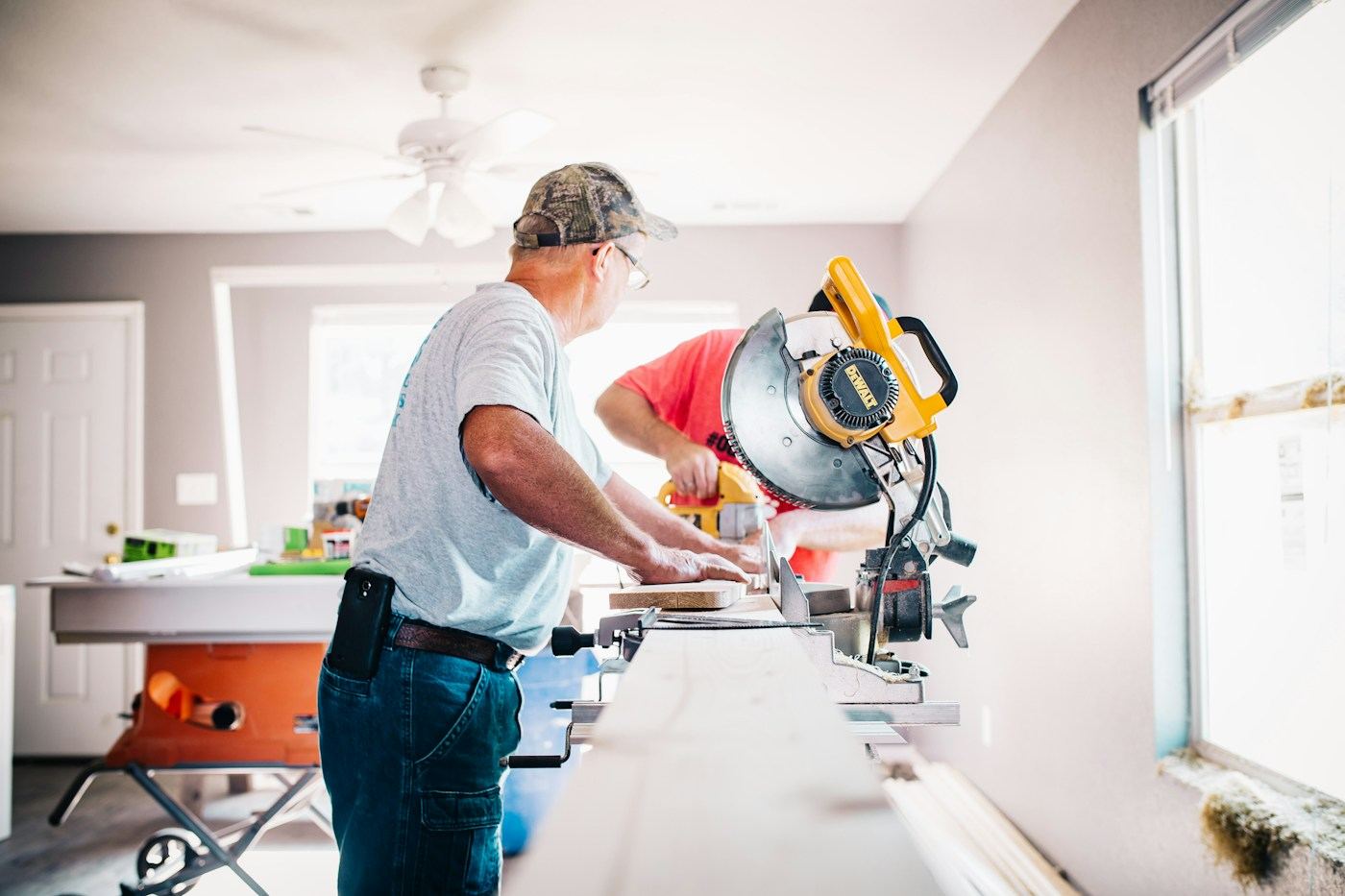 Northgate carpenter cutting trim with a miter saw