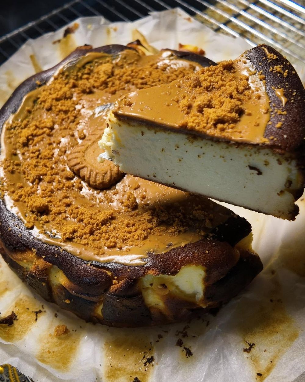 Biscoff burnt Basque cheesecake with a slice lifted out