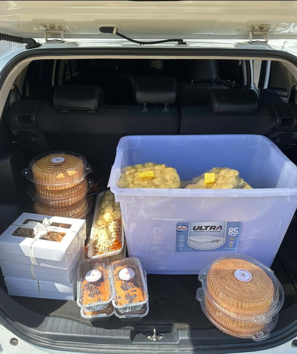 Car trunk packed with cakes, muffins and trays of puto ready for delivery